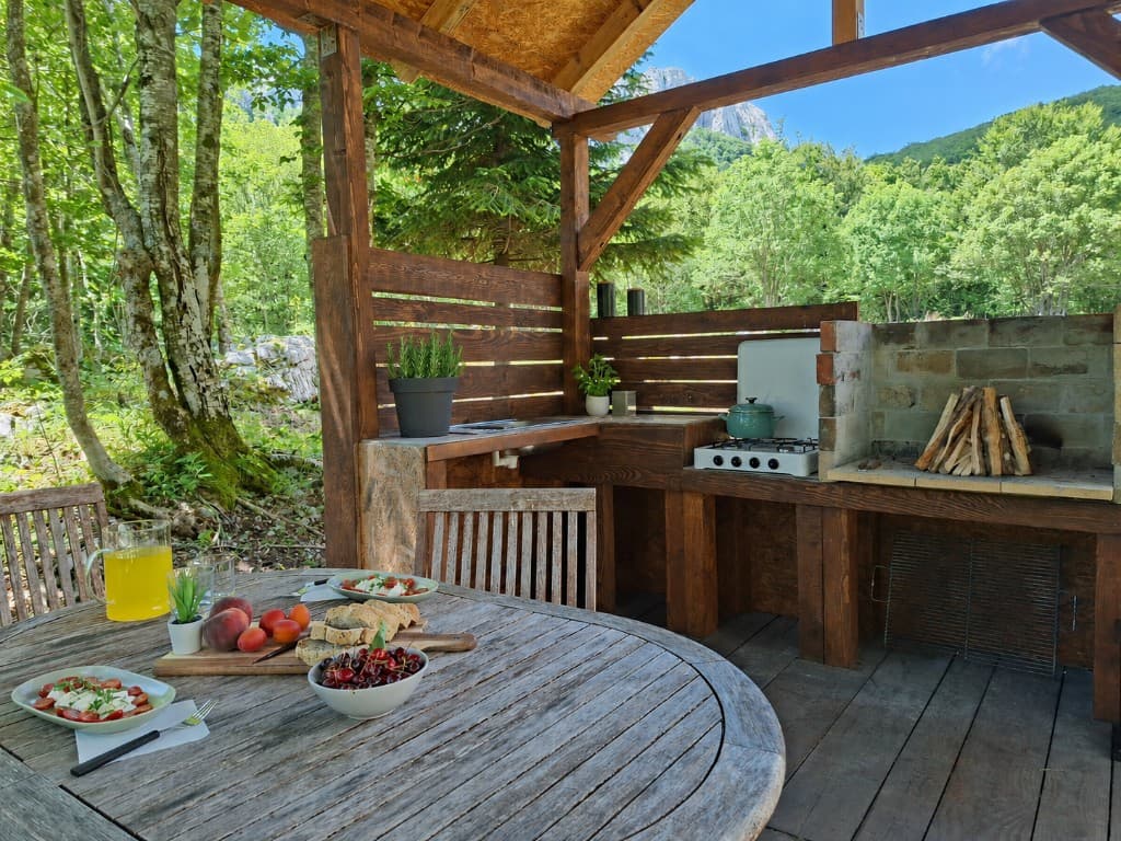 Outdoor kitchen table set for lunch with forest and mountain view at Stars Peak